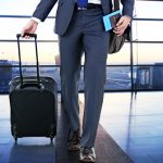 Business man with suitcase in hall of airport